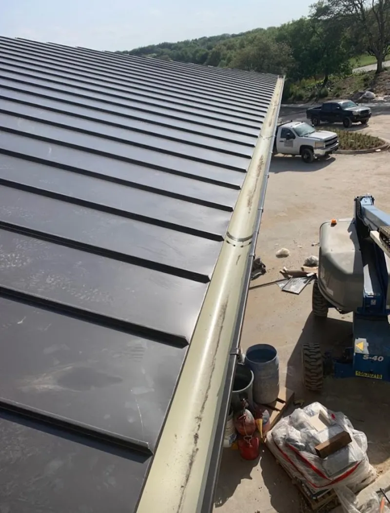 Standing seam panel and gutter detail on a metal roofing jobsite in Hercules